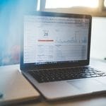 Laptop displaying Google Analytics in a modern workspace, highlighting digital analytics and technology.